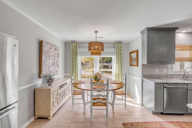 dining area featuring light tile patterned flooring, a wealth of natural light, and crown molding