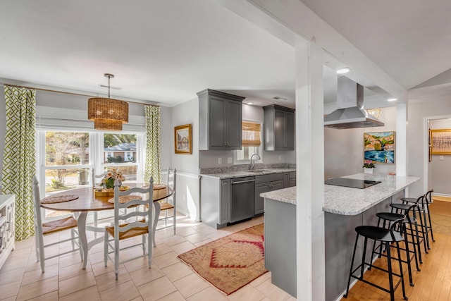 kitchen with gray cabinets, a sink, dishwasher, a kitchen breakfast bar, and extractor fan