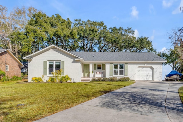 ranch-style home featuring a front yard, concrete driveway, brick siding, and an attached garage