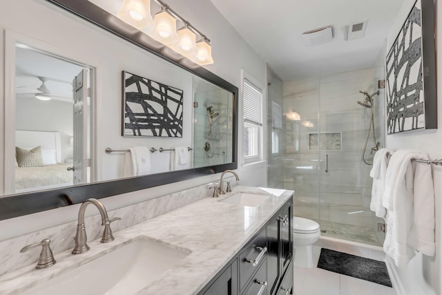 bathroom with double vanity, a stall shower, a sink, and visible vents