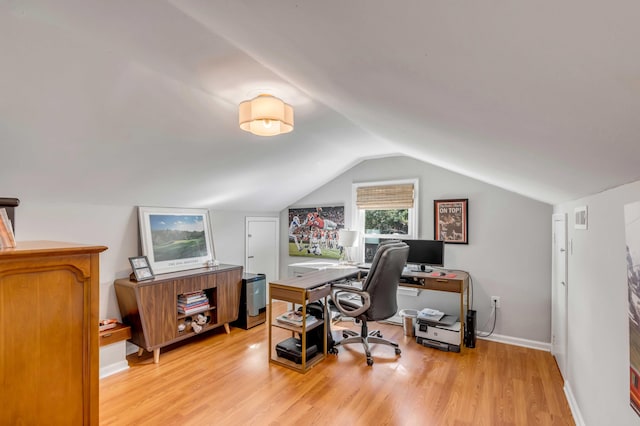 office with lofted ceiling, light wood-type flooring, visible vents, and baseboards