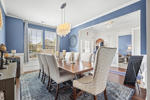 dining room with ornamental molding, dark wood finished floors, visible vents, and a notable chandelier