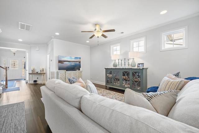 living area featuring baseboards, visible vents, dark wood-type flooring, crown molding, and recessed lighting