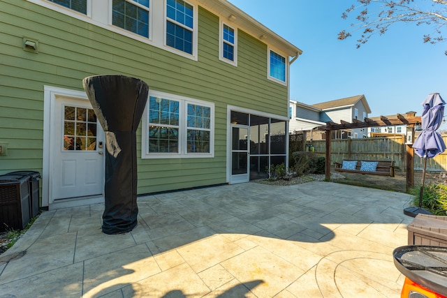 rear view of property with a patio area and fence