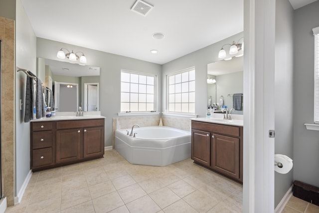 full bathroom with a bath, a sink, visible vents, and tile patterned floors