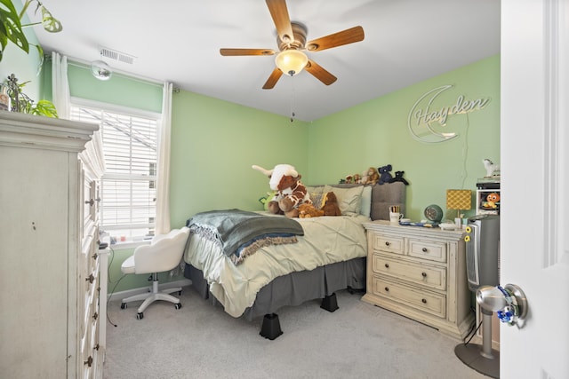 bedroom with ceiling fan, visible vents, and carpet flooring