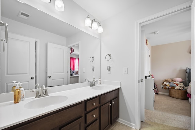 full bathroom featuring visible vents, a sink, baseboards, and double vanity