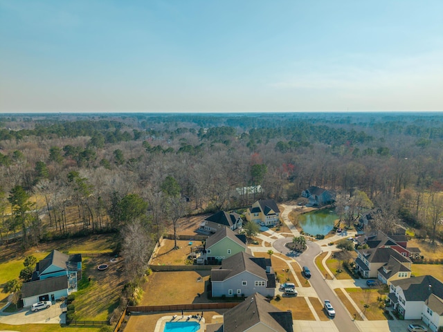 drone / aerial view with a residential view and a view of trees