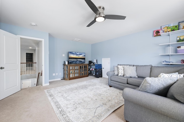 carpeted living area featuring ceiling fan and baseboards