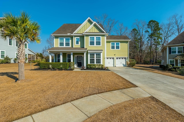 view of front of property with driveway, a front lawn, board and batten siding, and an attached garage