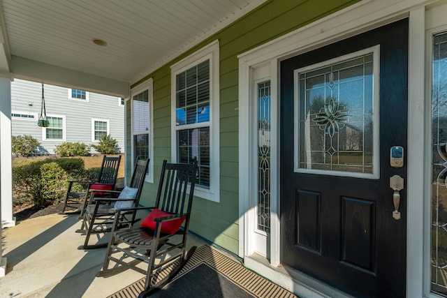 view of exterior entry with covered porch