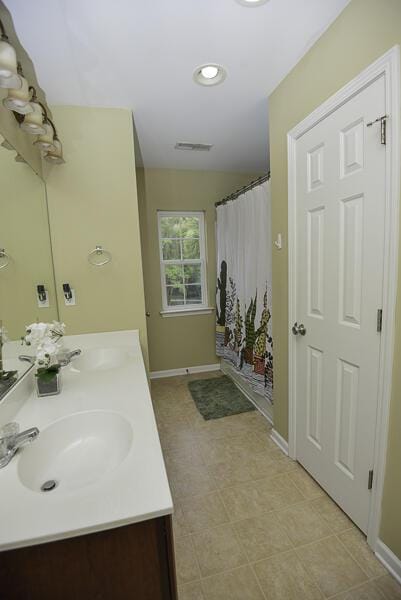 bathroom featuring vanity and shower / tub combo