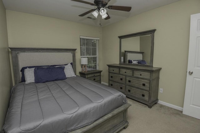 bedroom with ceiling fan and light carpet