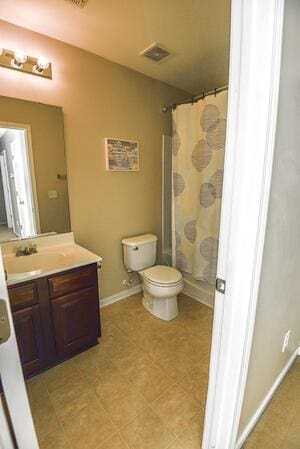 bathroom with vanity, toilet, and a shower with shower curtain