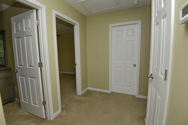 hall with light colored carpet