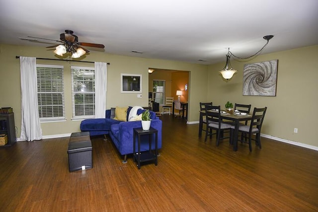 living room featuring dark hardwood / wood-style floors and ceiling fan