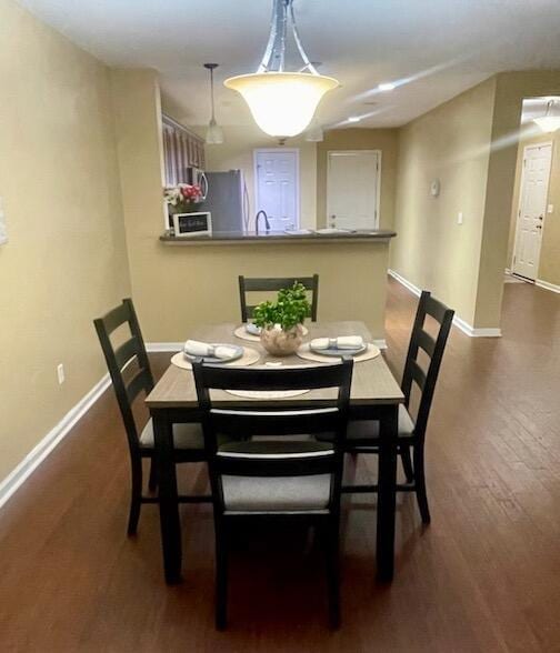 dining area featuring dark hardwood / wood-style flooring