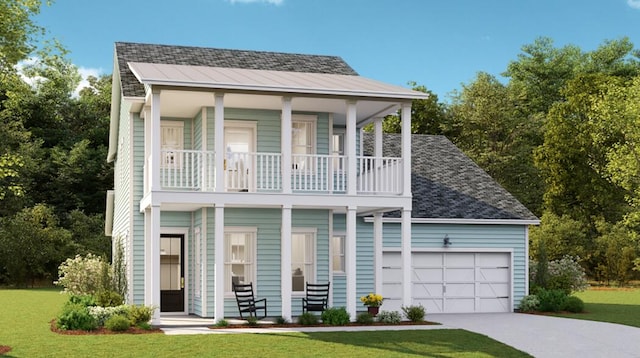 view of front of home featuring a front yard, a garage, and covered porch