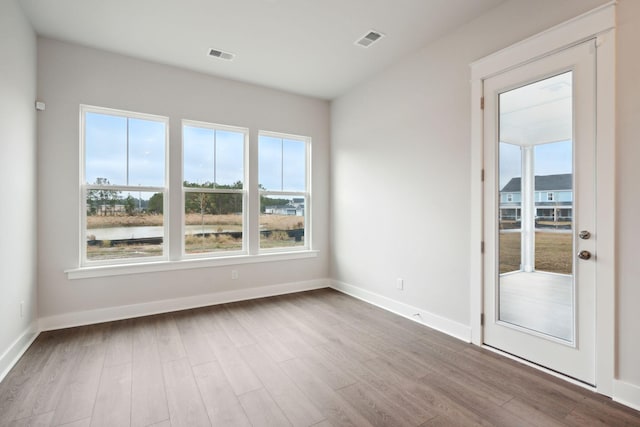 spare room featuring light wood-type flooring