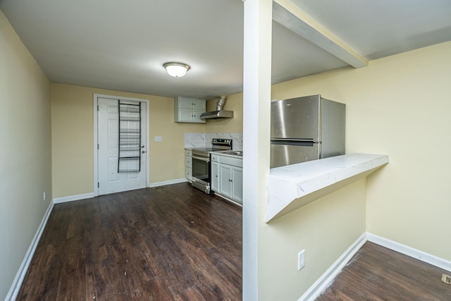 kitchen with baseboards, light countertops, appliances with stainless steel finishes, dark wood-style floors, and wall chimney exhaust hood