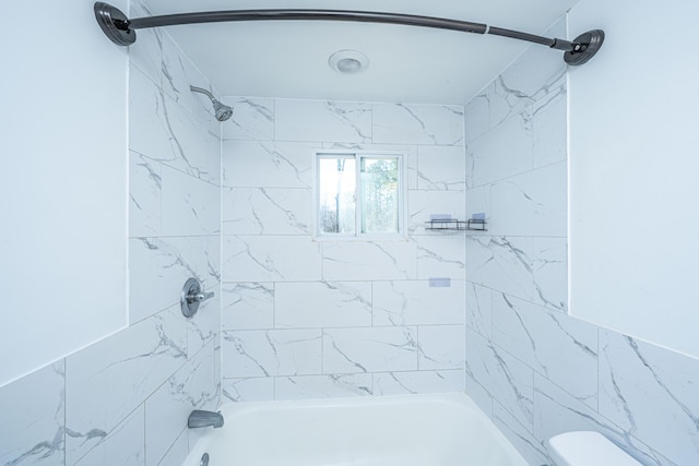 bathroom with shower / bathtub combination and toilet