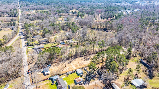 drone / aerial view with a wooded view