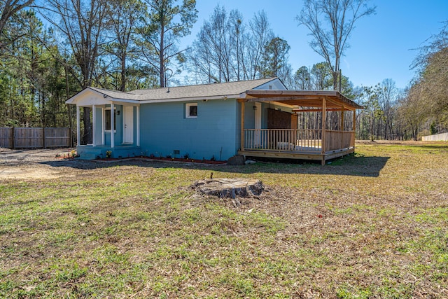 view of front of house with a front yard and fence