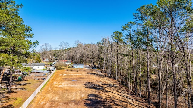 drone / aerial view with a wooded view