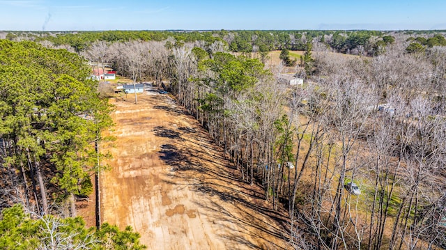 birds eye view of property featuring a forest view