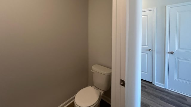 bathroom featuring hardwood / wood-style floors and toilet