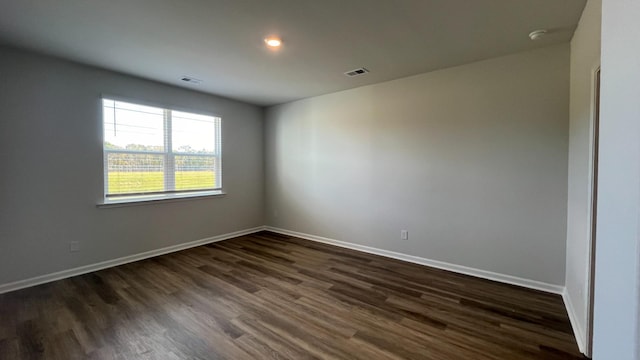 empty room with dark wood-type flooring