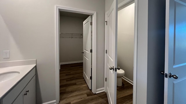 bathroom featuring hardwood / wood-style flooring, vanity, and toilet