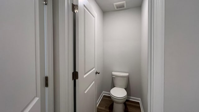 bathroom with wood-type flooring and toilet