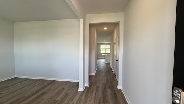 corridor featuring dark wood-type flooring