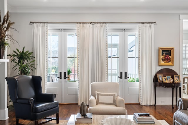 living area with french doors, dark wood-style flooring, plenty of natural light, and crown molding