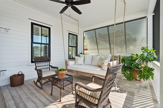 sunroom featuring ceiling fan