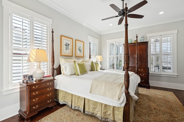 bedroom with dark wood finished floors, crown molding, recessed lighting, a ceiling fan, and baseboards