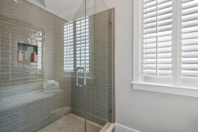 bathroom featuring a stall shower and vaulted ceiling