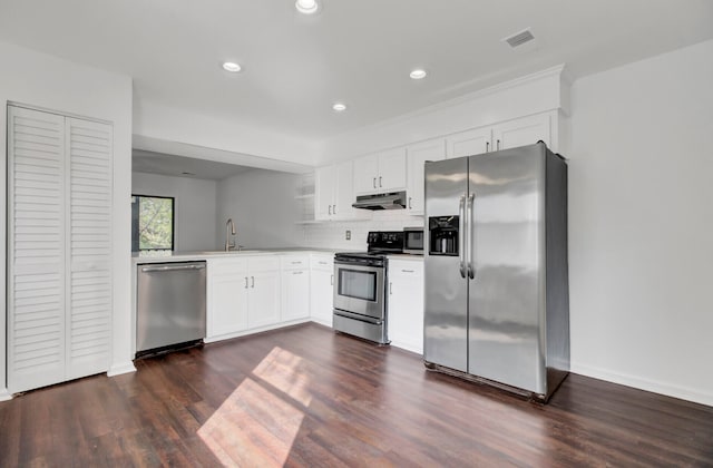 kitchen with sink, white cabinetry, stainless steel appliances, tasteful backsplash, and dark hardwood / wood-style flooring