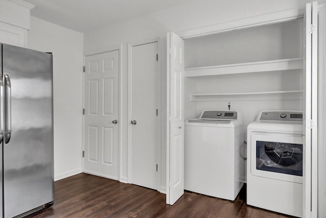 clothes washing area with dark wood-type flooring and washing machine and dryer