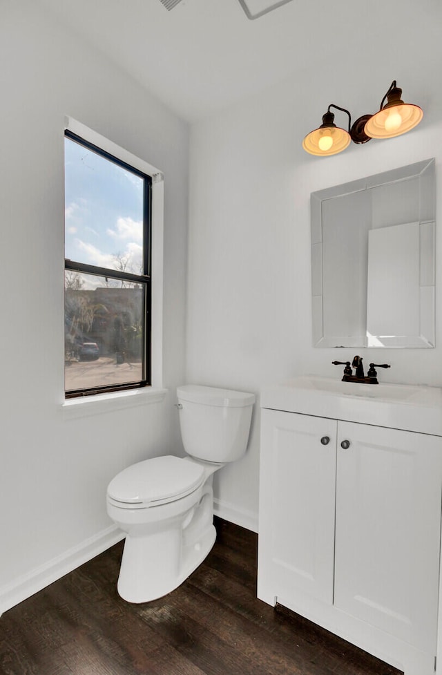 bathroom featuring vanity, hardwood / wood-style flooring, and toilet