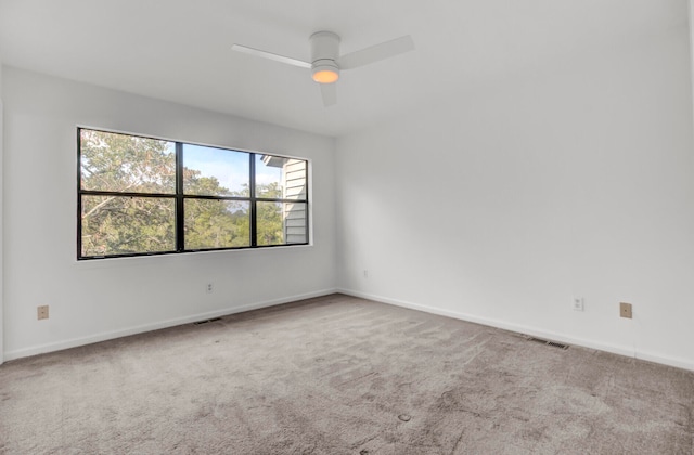 carpeted empty room featuring ceiling fan