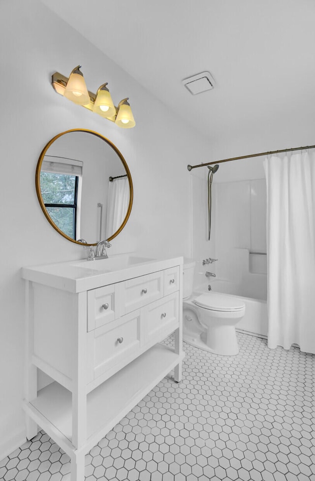 full bathroom with vanity, tile patterned floors, toilet, and shower / bath combo with shower curtain