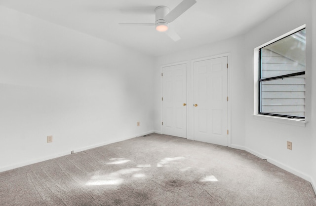 unfurnished bedroom featuring ceiling fan and carpet floors