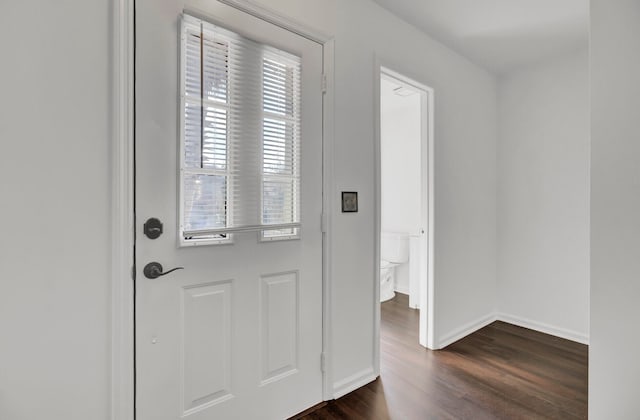 doorway with dark wood-type flooring