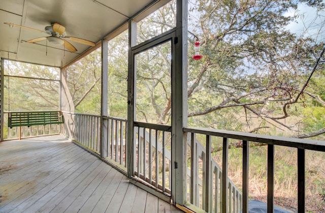 unfurnished sunroom with ceiling fan