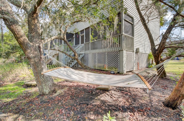 view of side of home with a sunroom