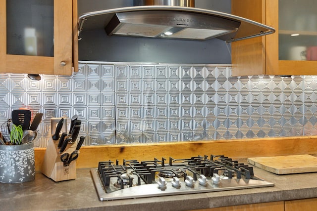 87 America St Unit A, B, C, Charleston, SC 29403 - kitchen with stainless steel gas stovetop, exhaust hood, and decorative backsplash