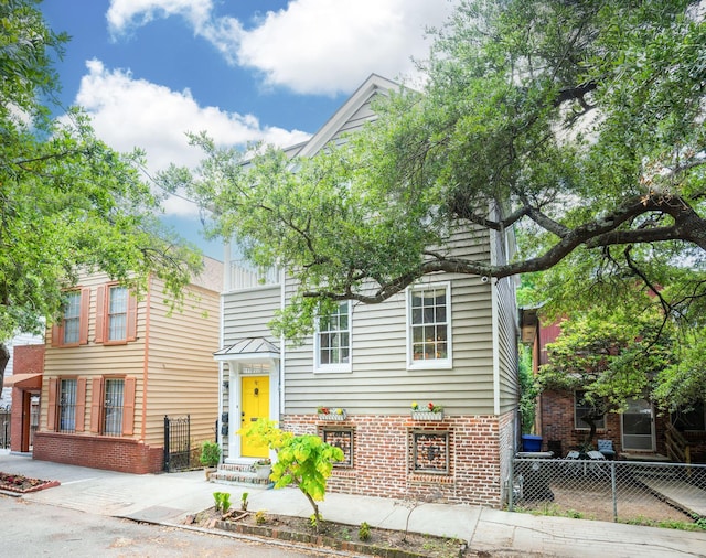 87 America St Unit A, B, C, Charleston, SC 29403 - view of front facade featuring fence and brick siding