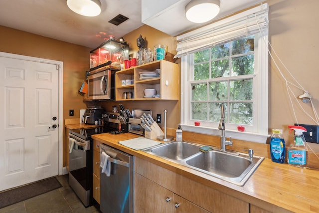 87 America St Unit A, B, C, Charleston, SC 29403 - kitchen with stainless steel appliances, a sink, dark tile patterned flooring, and open shelves